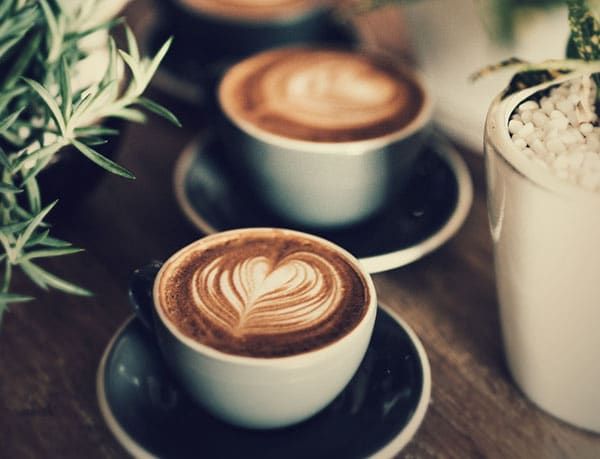 Two cappuccinos with latte art